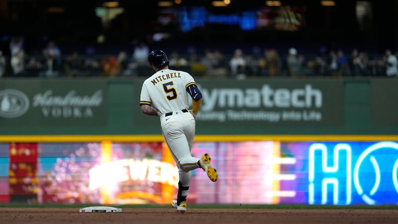 Milwaukee Brewers' Garrett Mitchell rounds the bases after hitting a solo home run during the...