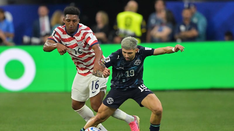 United States' Alex Freeman (16) and Paraguay's Julio Enciso (19) battle for the ball during...