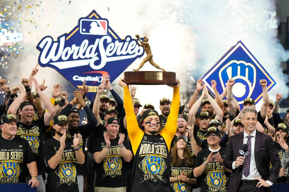 Milwaukee Brewers catcher William Contreras holds the MVP trophy after they won baseball's...