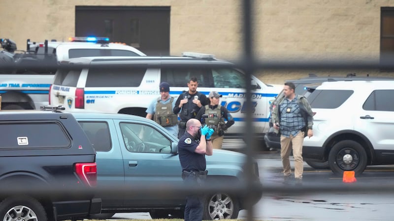 Police investigate as emergency vehicles are parked outside the Abundant Life Christian School...