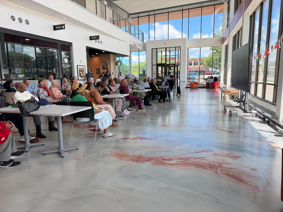 Dozens gathered at the Black Business Hub in Madison to watch the grand opening of the Obama...