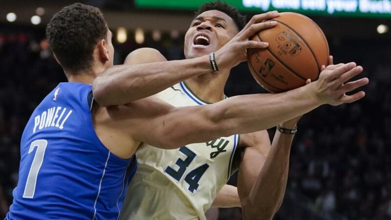 Milwaukee Bucks' Giannis Antetokounmpo tries to get past Dallas Mavericks' Dwight Powell...