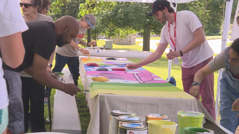 Sun Prairie residents paint a community mural to be displayed at Dream Park.