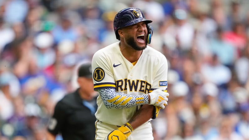 Milwaukee Brewers' Jackson Chourio reacts after being hit by a pitch thrown by Cleveland...