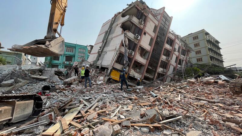 In this photo released by Xinhua News Agency, rescuers carry out search and rescue on the...
