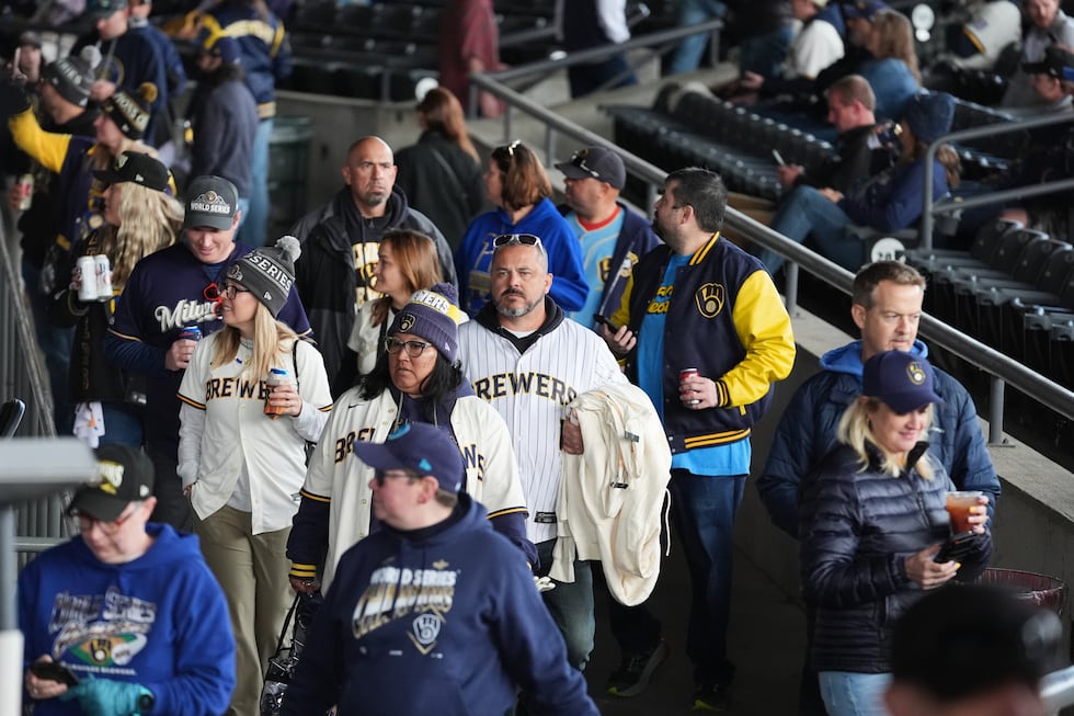 Milwaukee Brewers fans arrive for a rally during the baseball team's World Series parade,...