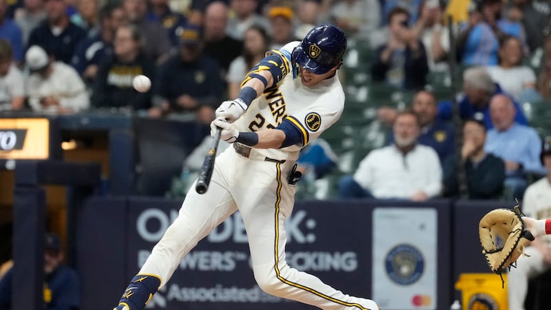 Milwaukee Brewers' Christian Yelich hits a solo home run during the first inning of a baseball...